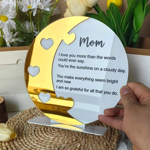 Detail of round acrylic Mother's Day plaque with golden crescent moon and heart cutout