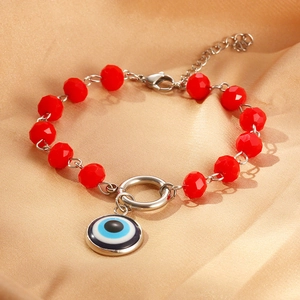 Retro stainless steel bracelet featuring red crystal beads and evil eye pendant on silk