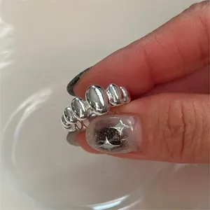 Detailed view of silver oval bead ring showing polished finish and sleek texture