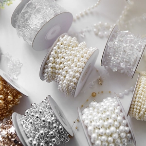 Assorted pearl bead chains on white spools for Christmas tree and DIY craft decoration