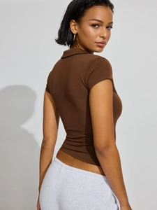 Close-up of dark brown polo shirt with slim-fit cut and button collar design