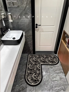 Detailed view of L-shaped black floral bathroom mat with water uptake technology