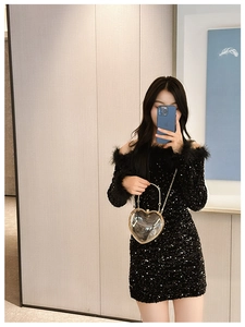 Chic heart-shaped acrylic crossbody bag with gold chain shown in a mirror selfie