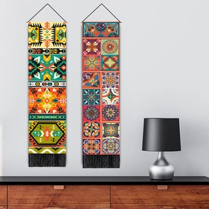 Bohemian wall hanging tapestries with geometric patterns and black tassels on white wall
