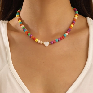 Colorful beaded necklace for women with white heart pendant and dopamine aesthetic style
