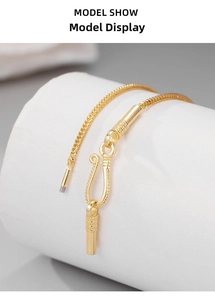 Macro shot of gold keel chain necklace featuring a vintage S-hook clasp detail