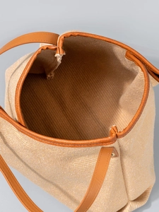 Oatmeal canvas tote bag with brown leather handles and spacious interior main view