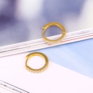 Macro detail of gold S925 silver square hoop earrings with sparkling zircon inlay
