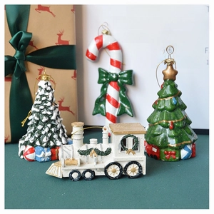 Christmas tree ornaments featuring Santa, candy cane, and train set in festive scene