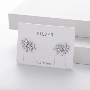 Macro shot of S925 sterling silver snowflake earrings with sparkling white gemstones