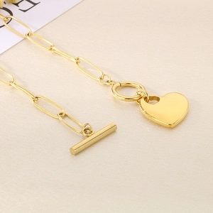 Detail of 18K gold plated paperclip chain necklace with heart pendant and OT toggle clasp