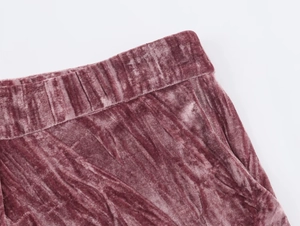 Detail shot of the elastic waistband and pleated velvet fabric texture in dusty pink
