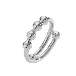 Macro detail of silver double-layered ring with polished metal beads in minimalist style