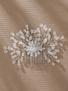 Detailed close-up of bridal hair comb with silver wires, clear crystals and pearls