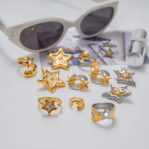 Star shaped stainless steel jewelry collection with gold and silver rings and earrings
