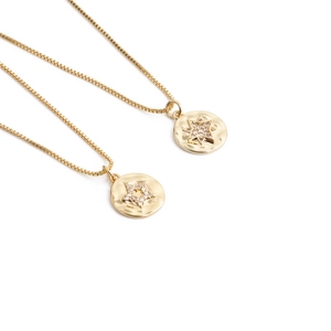Gold star pendant box chain necklaces featuring sparkling zircon stones on a white background