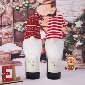 Knitted gnome wine bottle covers with long white beards for Christmas table decorations