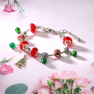 DIY Christmas bracelet with red and green beads and a silver Christmas tree pendant