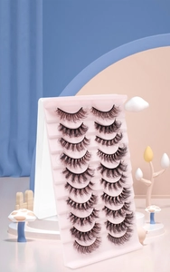 Close-up of 10 pairs of dense natural curly false eyelashes on a creative colorful display