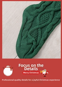 Macro detail of 46cm green wool cable knit Christmas stocking on light wood background