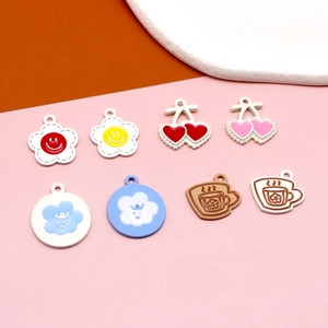 Detailed flat lay of cute frosted alloy DIY charms in floral and animal head shapes