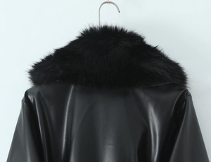 Detailed view of women's black faux leather coat featuring a premium faux fur collar trim