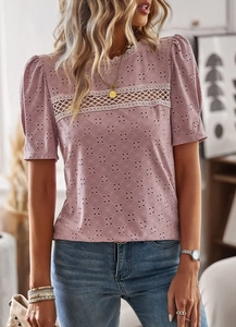 Close-up of pink hollow embroidery and lace patchwork on casual short sleeve top