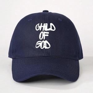 Detail of white Child of God print on a dark blue cotton twill baseball cap