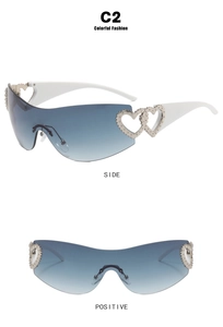Close-up of Y2K sunglasses featuring silver heart accents and gradient blue lenses