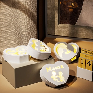Close-up of luminous heart-shaped DIY resin lamp featuring mama cutout and warm LED light