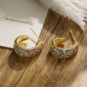 Detail of C-shaped gold-plated earrings featuring vibrant multi-colored zircon stones
