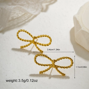 Detail of gold bow earrings featuring twisted metal texture and dimensions 3.4cm by 1.7cm