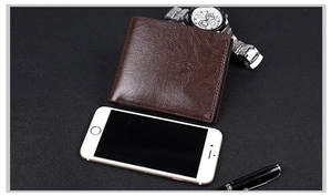 Deep brown leather bifold wallet shown with a smartphone and watch for size reference