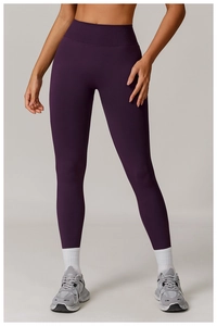 Detail of high waist seamless yoga leggings in deep purple showing fabric texture