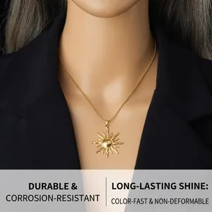 Detailed shot of sun totem gold-plated stainless steel pendant on snake chain worn by model