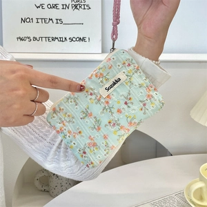 Close-up of floral fabric pouch with pink lanyard and secure zipper closure