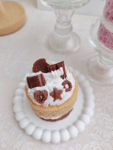 Macro shot of cupcake candle with realistic cream, chocolate, and biscuit detail