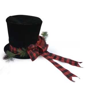 Detail of black velvet Christmas hat featuring tartan bow, pine needles and pine cones