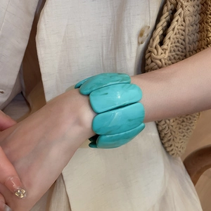 Detailed view of turquoise marbled acrylic rectangle link bracelet on model wrist