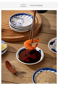 Close-up of Japanese cat ceramic soy sauce dishes on a wooden table setup