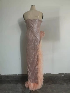 Detail of pink sequin evening gown showing ruffled hemline and mermaid tail design