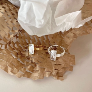 Detailed macro view of S925 sterling silver ring with rectangular zircon and gold finish