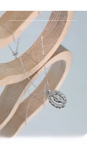 Macro view of S925 sterling silver tulip pendant with hollowed oval frame and fine chain