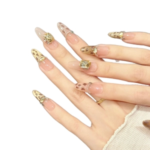Handmade leopard print press-on nails with champagne rhinestones and pearl accents