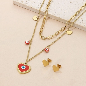 Detail of gold layered necklace with evil eye pendants and matching heart stud earrings