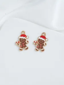 Detailed view of gingerbread man charms with red hats for DIY Christmas jewelry making