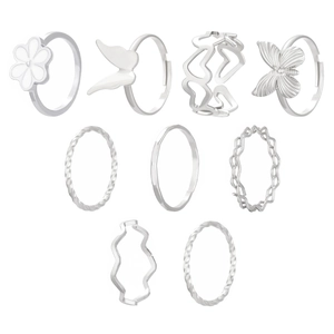 Macro detail of a 9-piece vintage silver flower and baroque pearl ring set for women