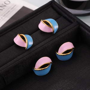 Retro color-block wavy earrings with pink and blue enamel glaze on a black velvet box