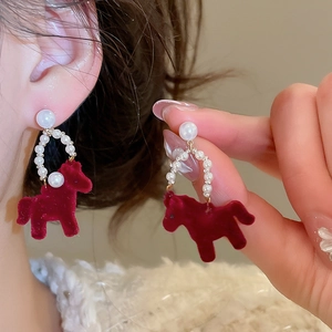Detail of red flocked pony earrings with pearls and silver needle for elegant retro style