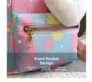 Detail of colorful gradient backpack with heart patterns and a plush charm attachment